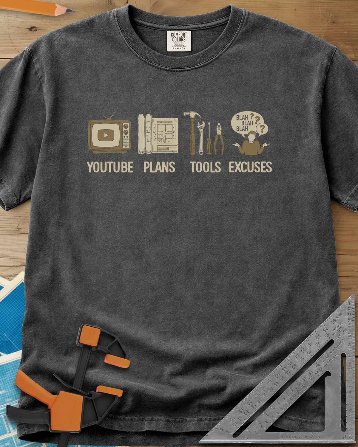 The DIY Loop heavyweight tee in Pepper, a retro TV, rolled plans, hand tools and a shrugging figure