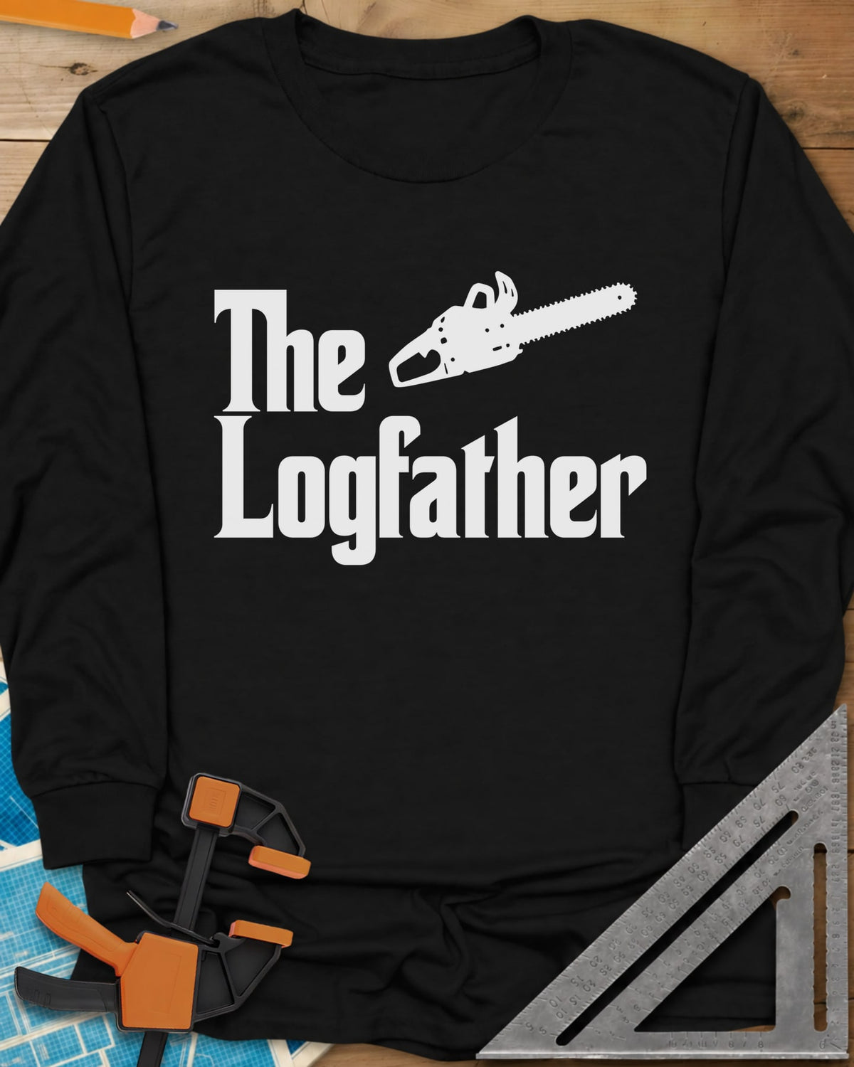 The Logfather long sleeve shirt in Black, serif lettering with a chainsaw beside the word The