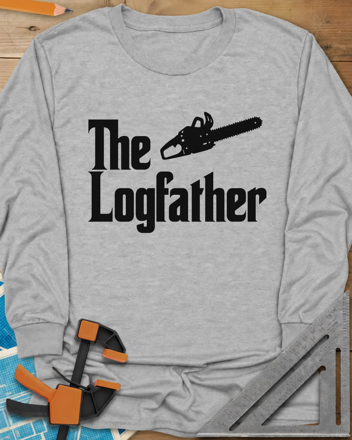 The Logfather long sleeve shirt in Sport Grey, serif lettering with a chainsaw beside the word The