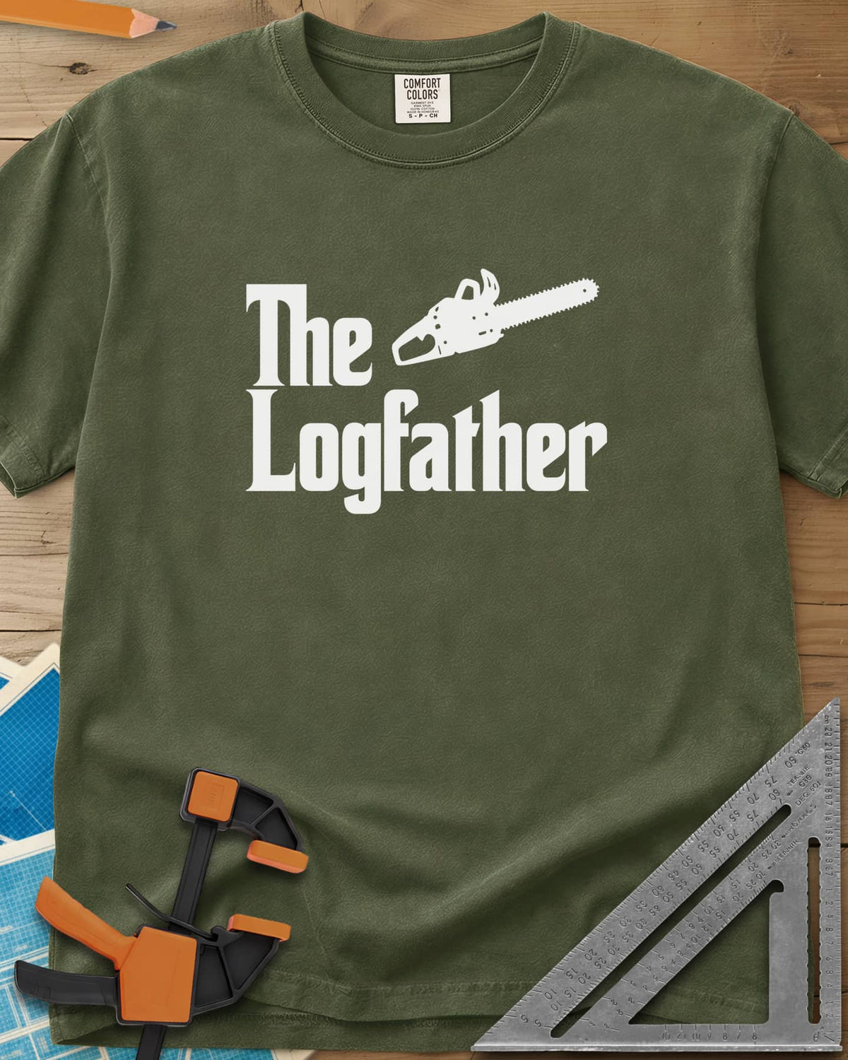 The Logfather heavyweight tee in Hemp, serif lettering with a chainsaw beside the word The