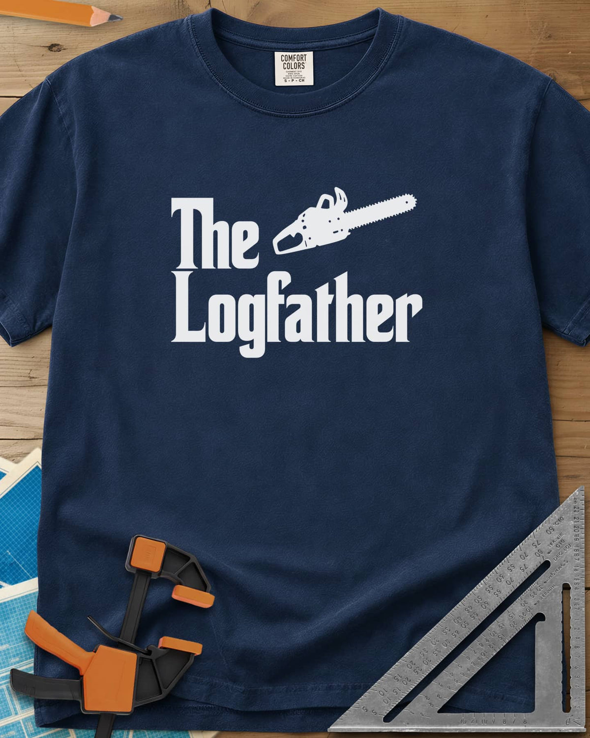 The Logfather heavyweight tee in Navy, serif lettering with a chainsaw beside the word The