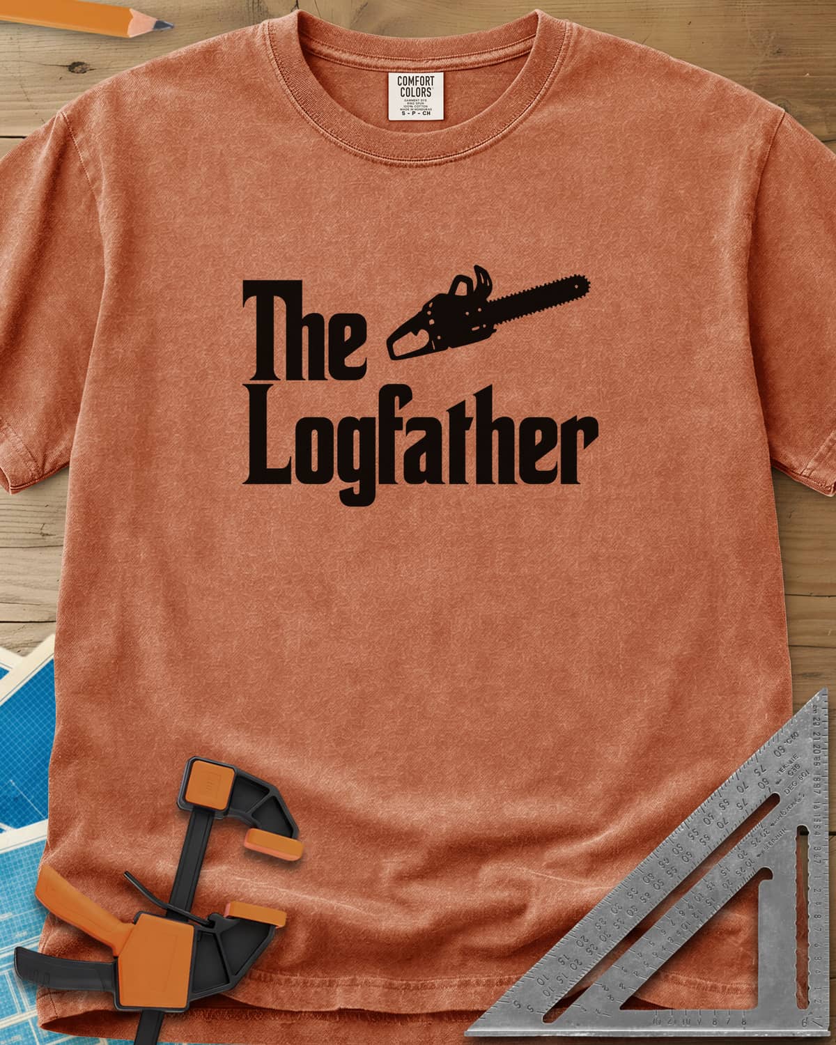 The Logfather heavyweight tee in Yam, serif lettering with a chainsaw beside the word The