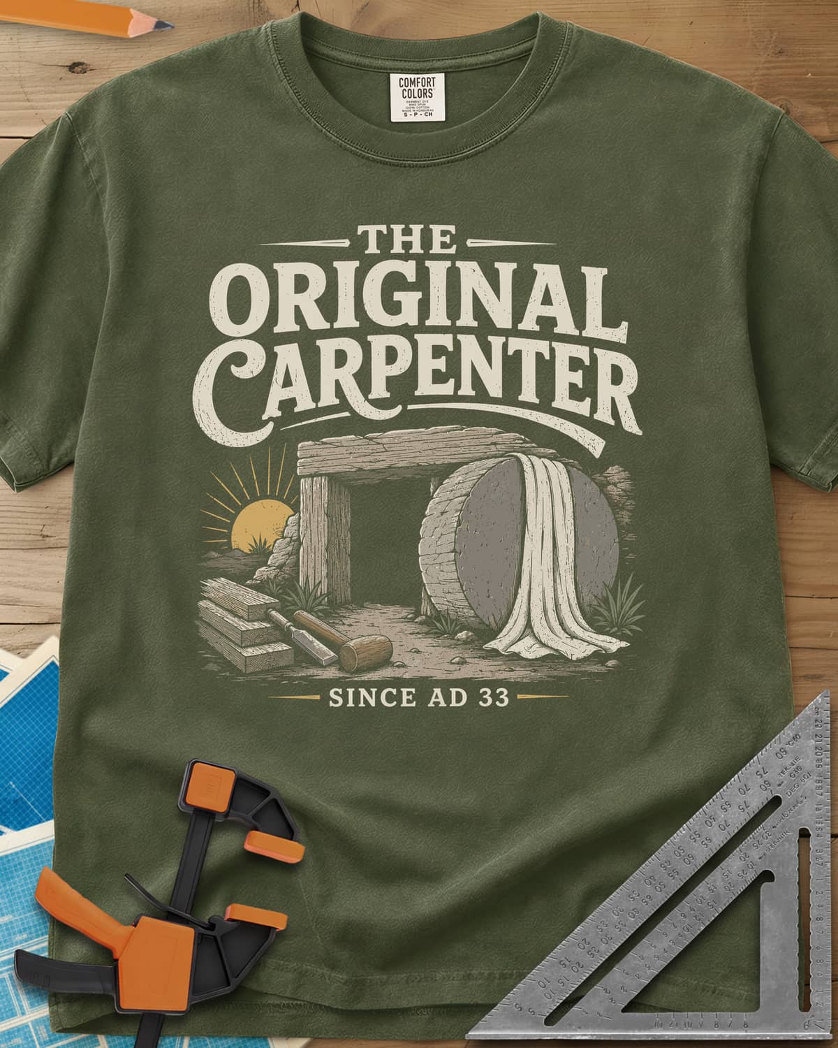 The Original Carpenter heavyweight tee in Hemp, an empty tomb at sunrise with planks, a mallet and a chisel