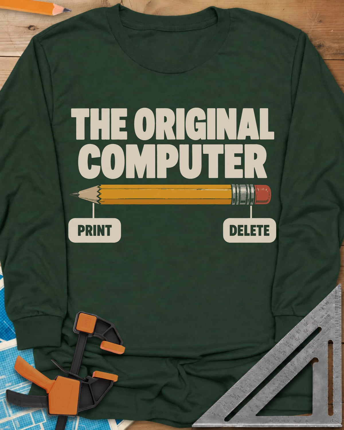 The Original Computer long sleeve shirt in Forest Green, a yellow pencil labeled PRINT at the point and DELETE at the eraser