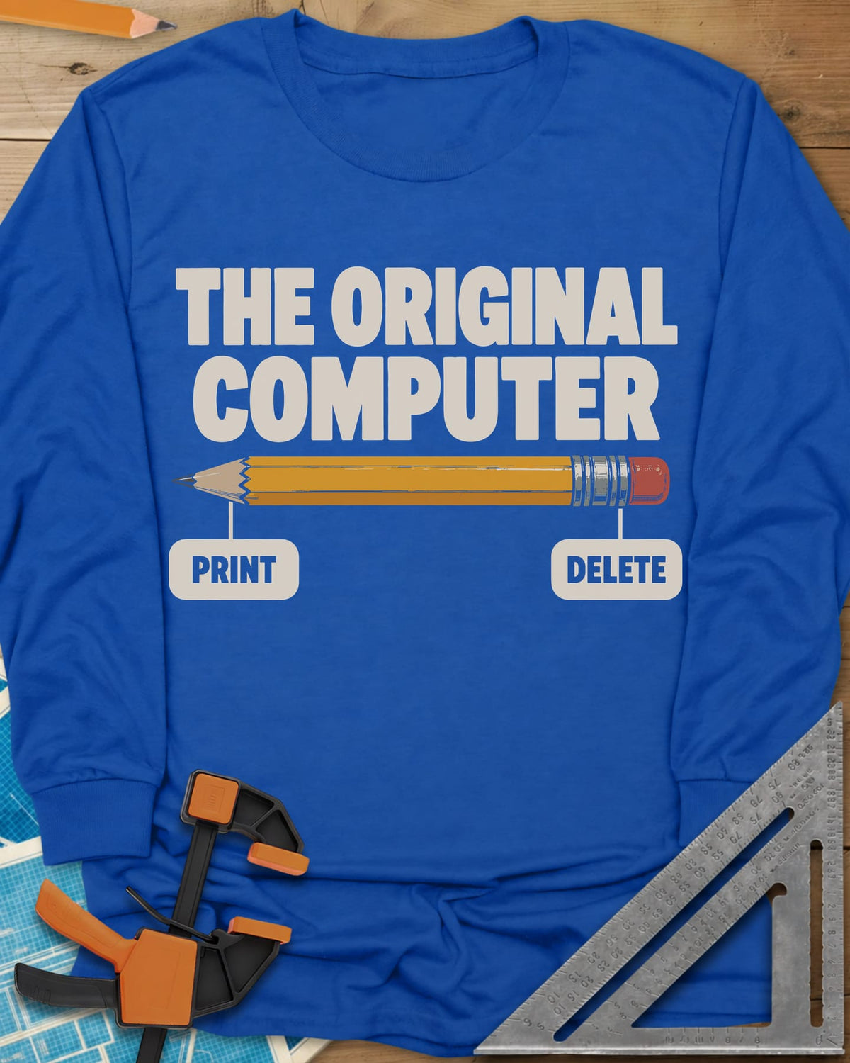 The Original Computer long sleeve shirt in Royal, a yellow pencil labeled PRINT at the point and DELETE at the eraser