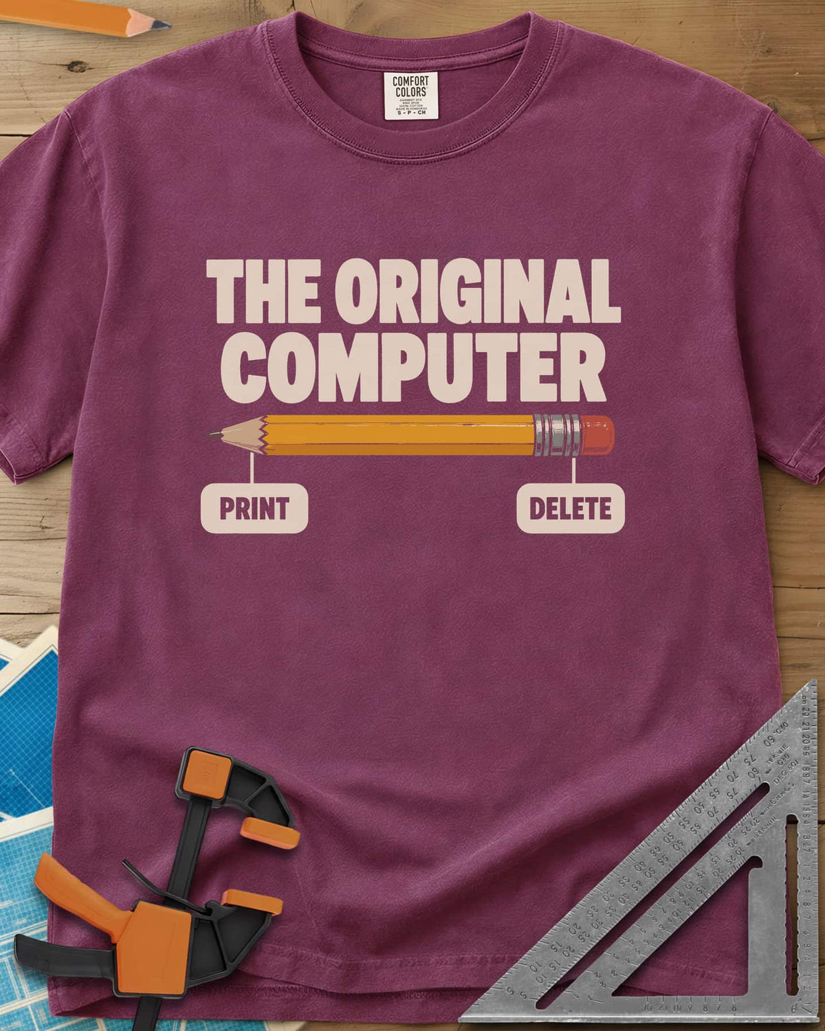 The Original Computer heavyweight tee in Berry, a yellow pencil labeled PRINT at the point and DELETE at the eraser