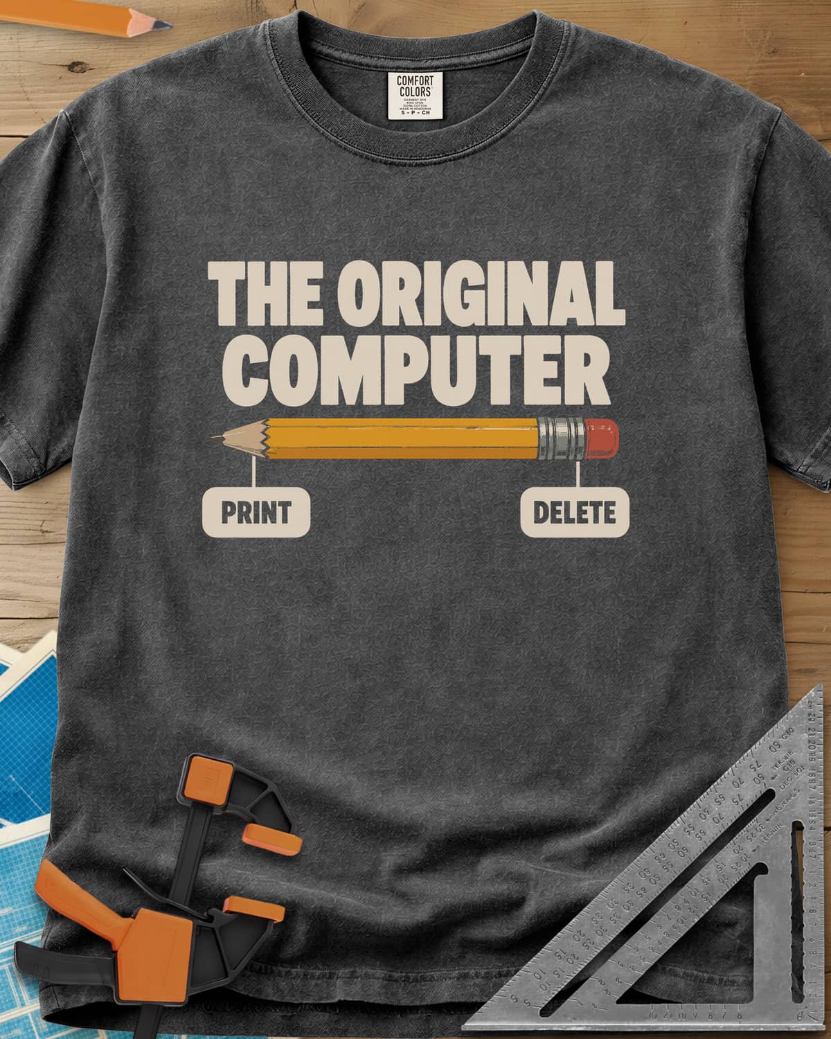 The Original Computer heavyweight tee in Pepper, a yellow pencil labeled PRINT at the point and DELETE at the eraser