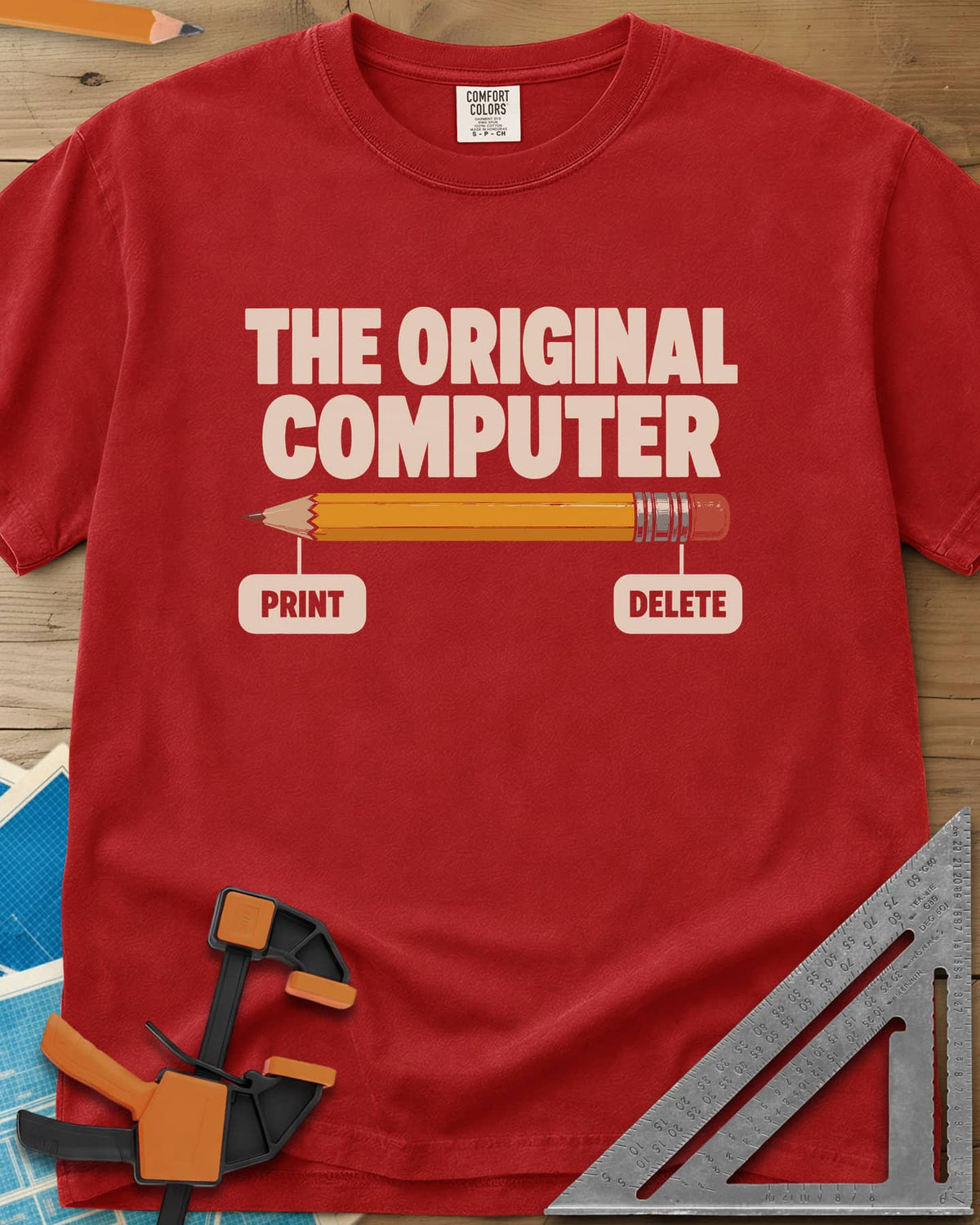 The Original Computer heavyweight tee in Red, a yellow pencil labeled PRINT at the point and DELETE at the eraser