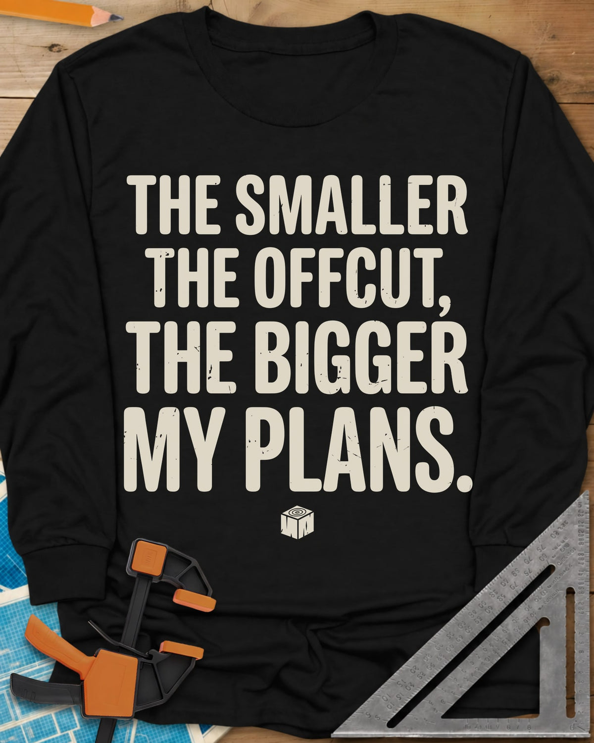 The Smaller The Offcut long sleeve shirt in Black, bold stacked capitals above a tiny end-grain cube mark