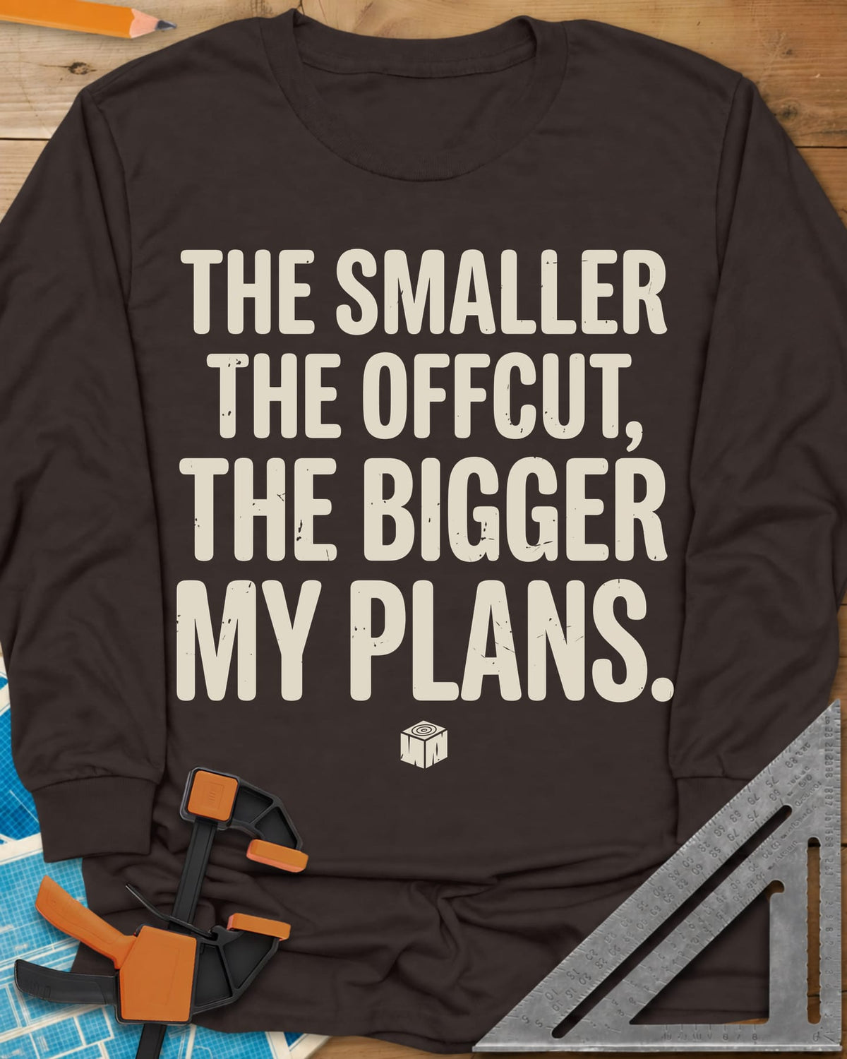 The Smaller The Offcut long sleeve shirt in Dark Chocolate, bold stacked capitals above a tiny end-grain cube mark