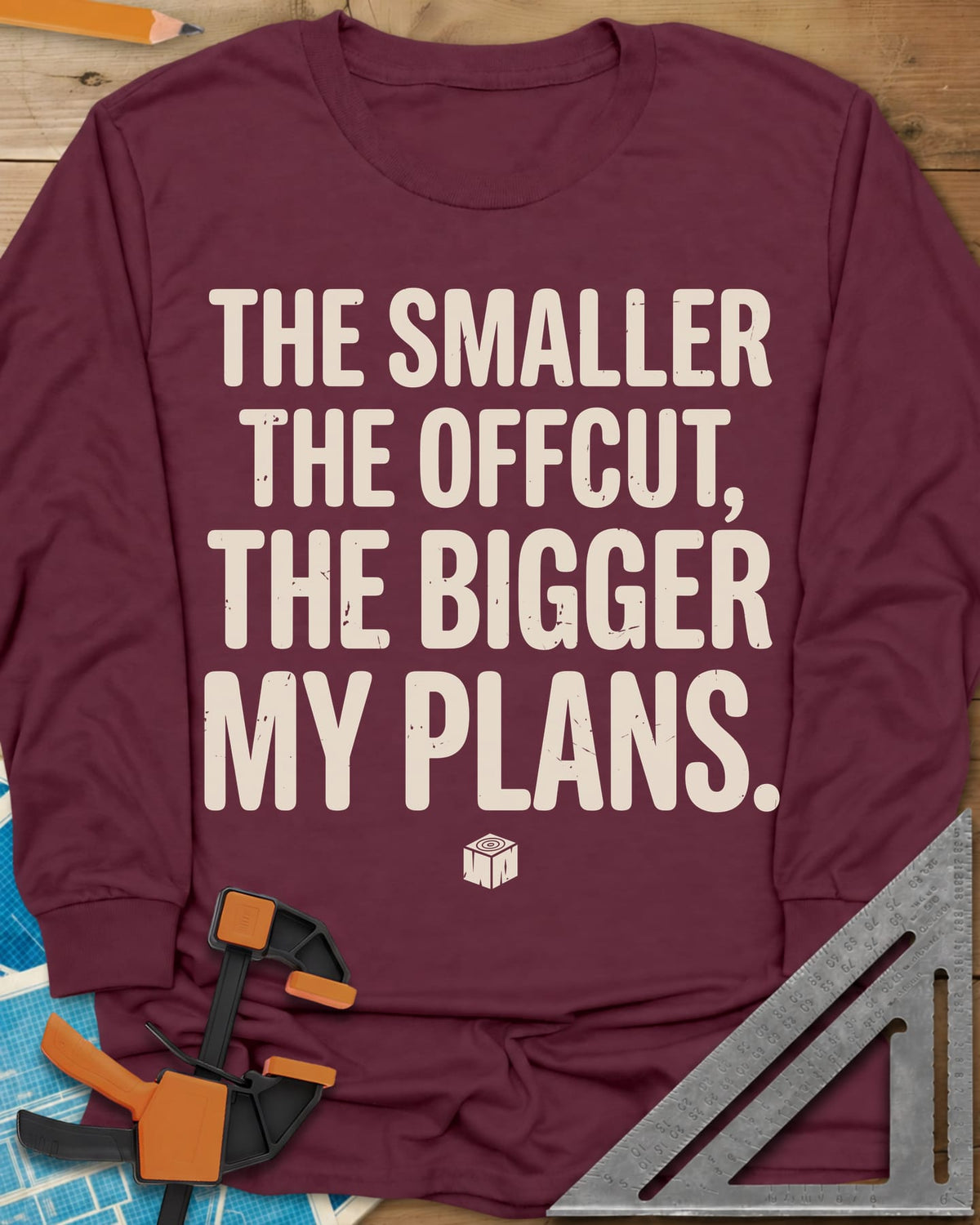 The Smaller The Offcut long sleeve shirt in Maroon, bold stacked capitals above a tiny end-grain cube mark