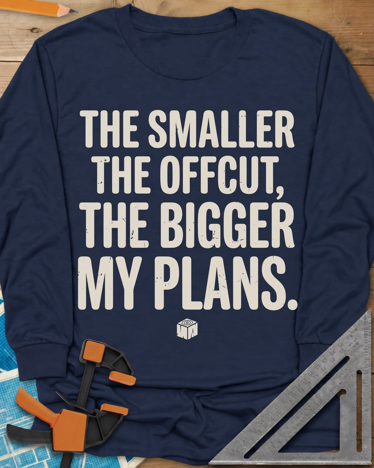 The Smaller The Offcut long sleeve shirt in Navy, bold stacked capitals above a tiny end-grain cube mark