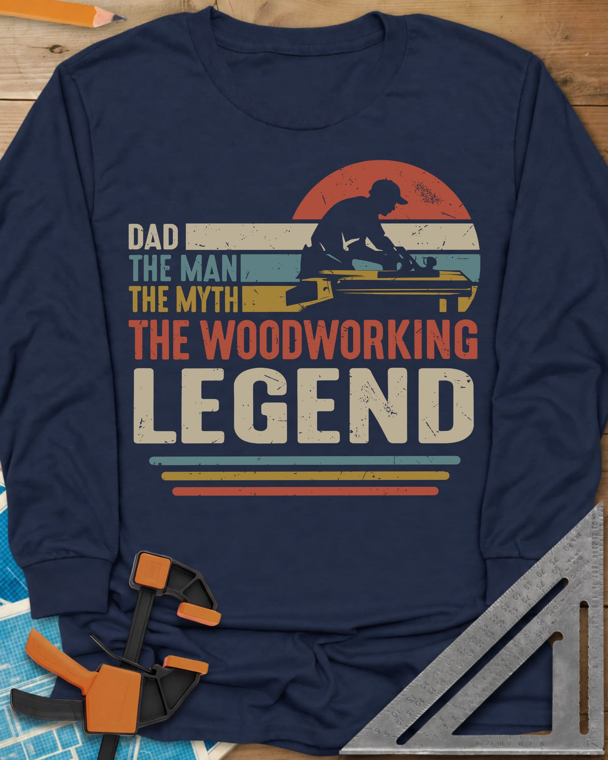 The Woodworking Legend long sleeve shirt in Navy, retro sunset stripes behind a silhouetted woodworker at his bench