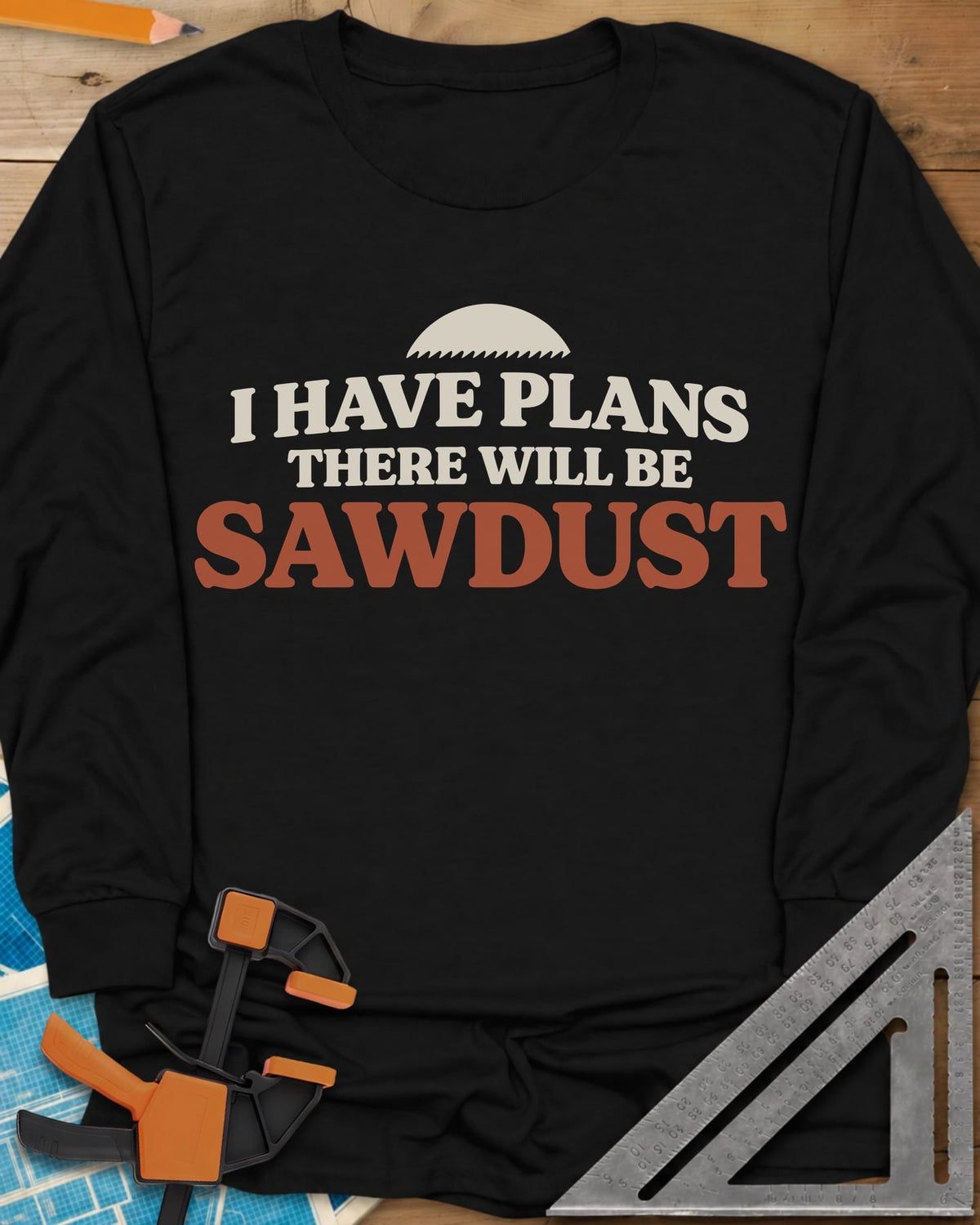There Will Be Sawdust long sleeve shirt in Black, half a toothed saw blade above rounded, bold lettering