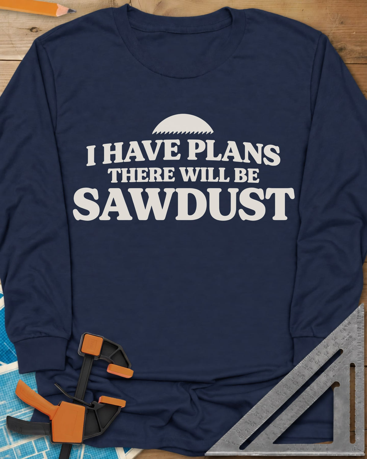 There Will Be Sawdust long sleeve shirt in Navy, half a toothed saw blade above rounded, bold lettering