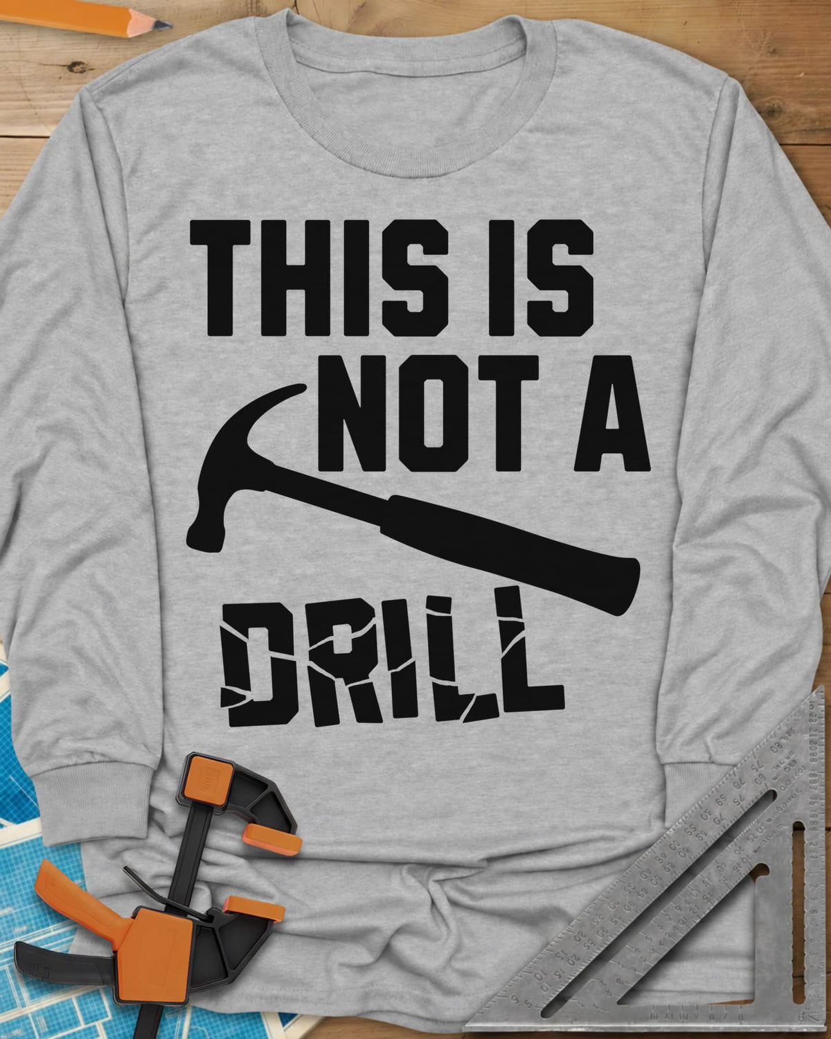 This is Not a Drill long sleeve shirt in Sport Grey, a claw hammer across the lettering, with DRILL cracked apart