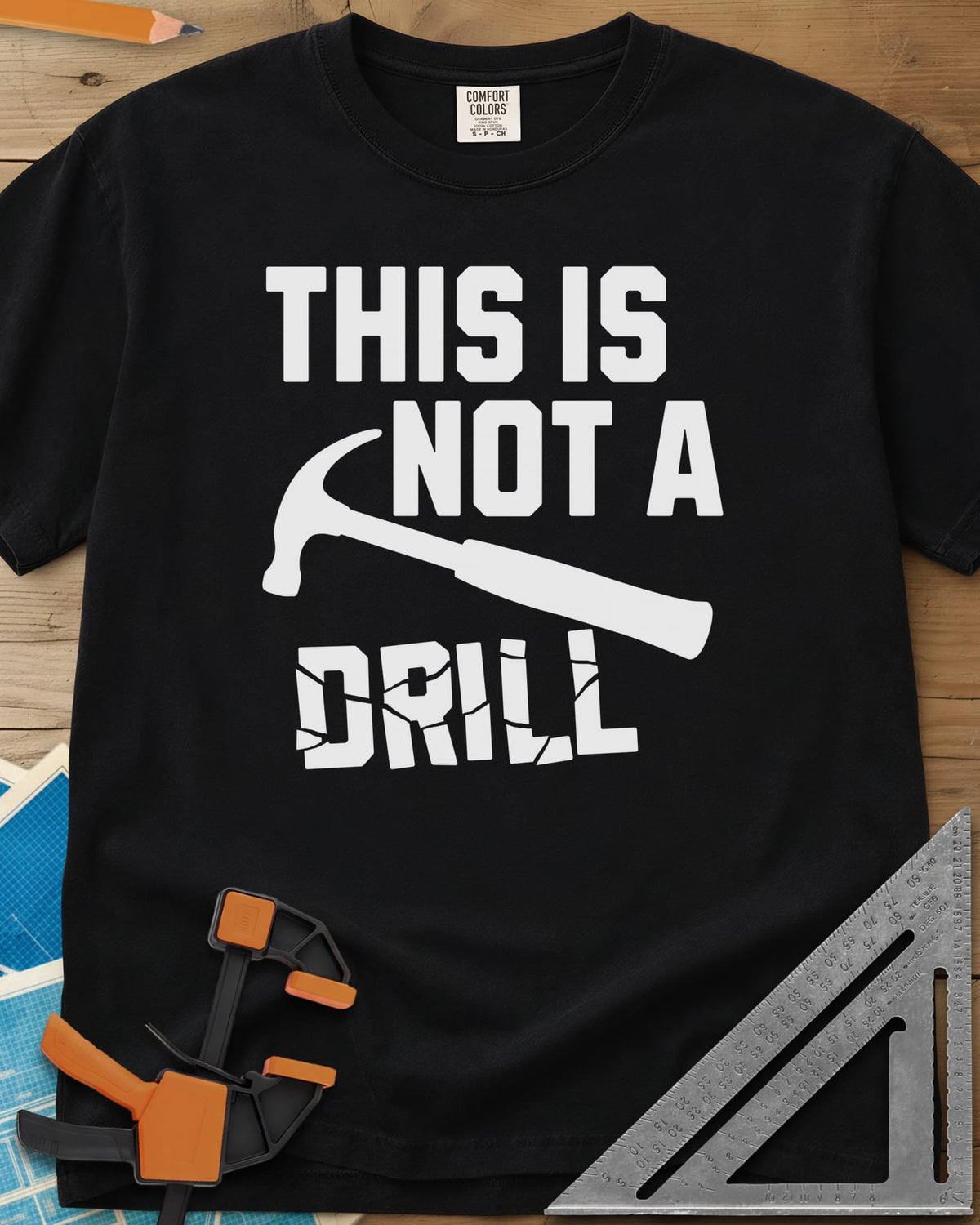 This is Not a Drill heavyweight tee in Black, a claw hammer across the lettering, with DRILL cracked apart