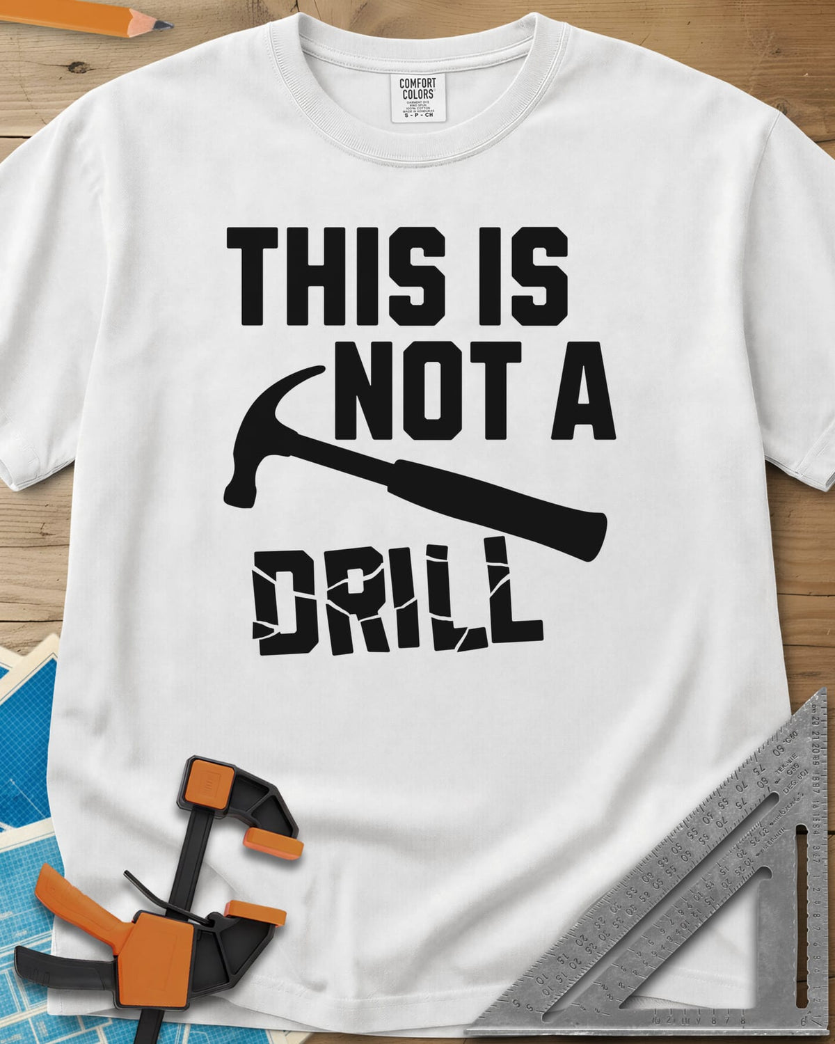 This is Not a Drill heavyweight tee in White, a claw hammer across the lettering, with DRILL cracked apart
