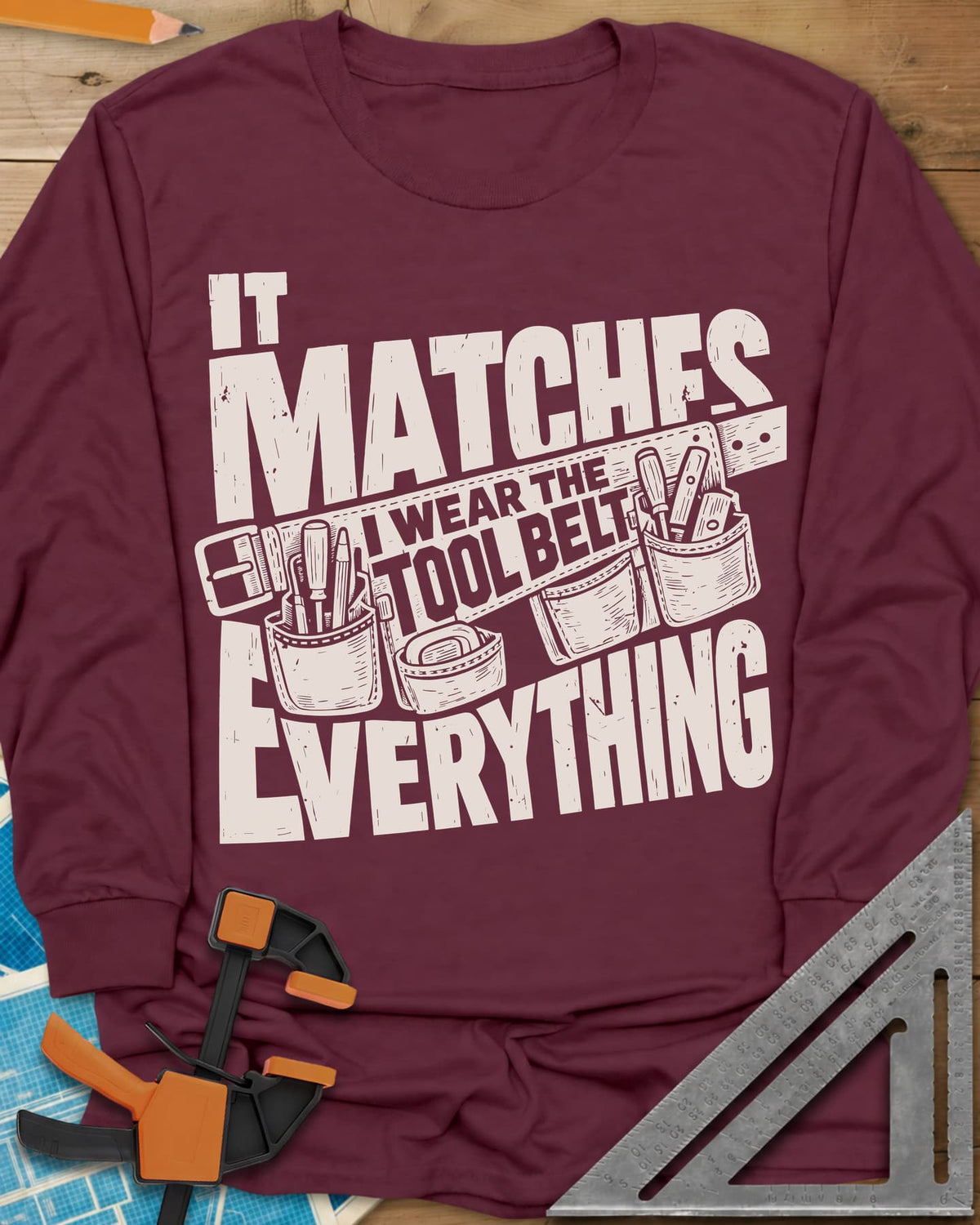 Tool Belt long sleeve shirt in Maroon, a pouched tool belt behind worn block lettering