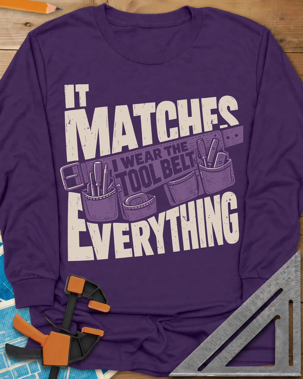 Tool Belt long sleeve shirt in Purple, a pouched tool belt behind worn block lettering
