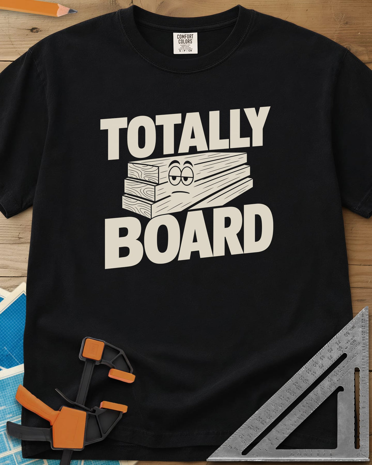 Totally Board heavyweight tee in Black, a stack of three planks wearing a bored, half-lidded face