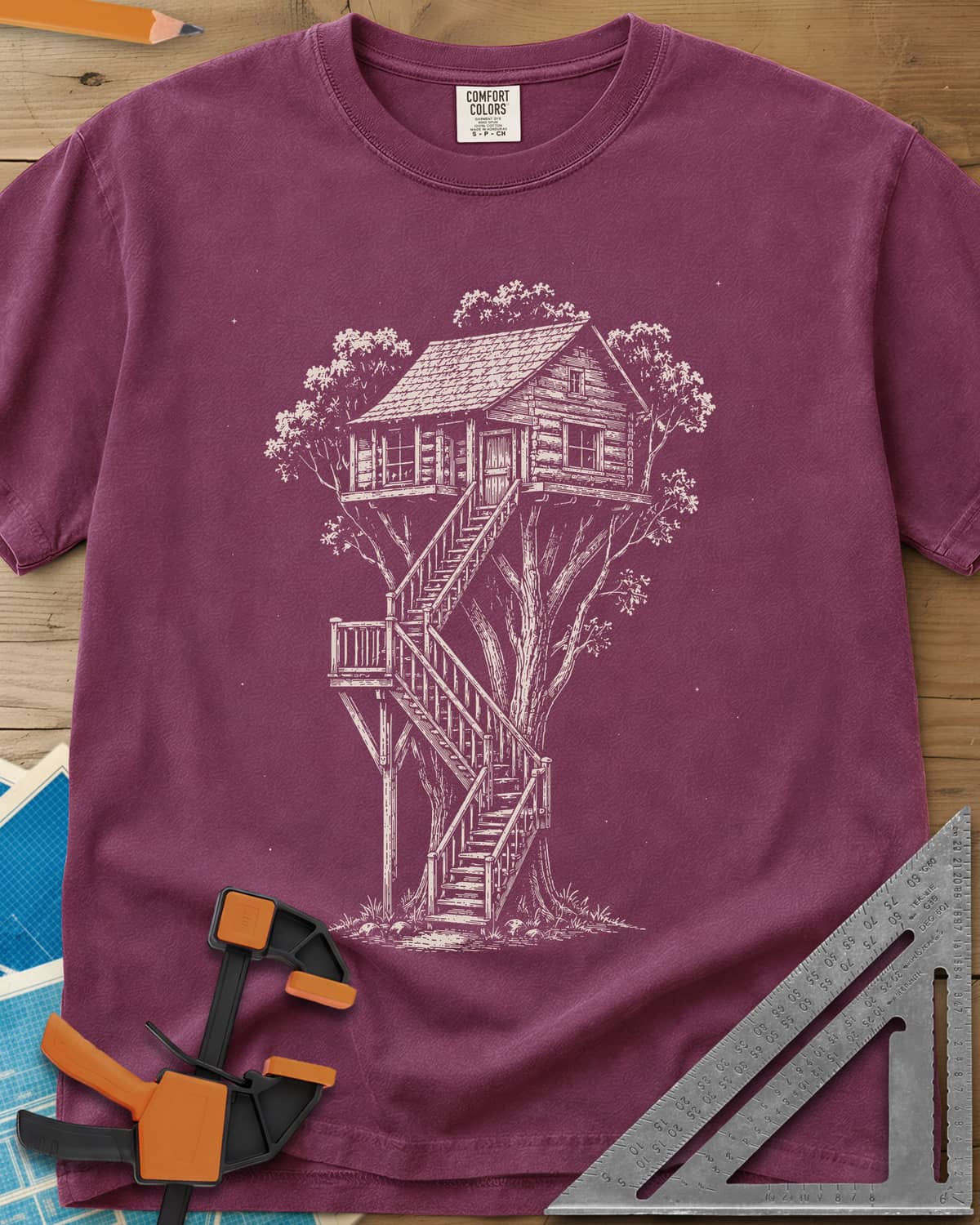 Treehouse Dream Build heavyweight tee in Berry, ink-style log cabin treehouse with a zigzag staircase