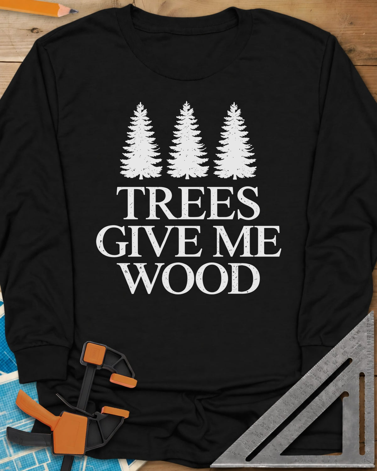 Trees Give Me Wood long sleeve shirt in Black, three evergreen trees above worn serif lettering