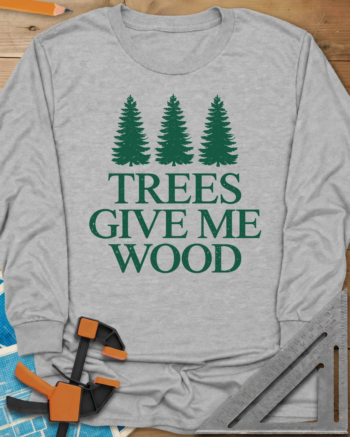 Trees Give Me Wood long sleeve shirt in Sport Grey, three evergreen trees above worn serif lettering