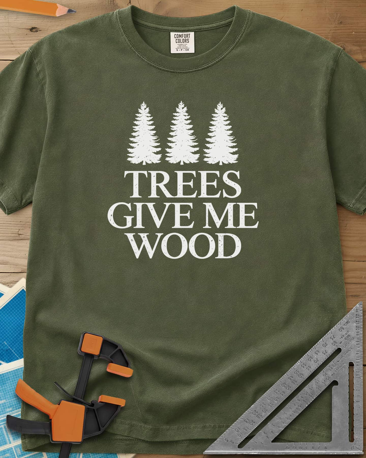 Trees Give Me Wood heavyweight tee in Hemp, three evergreen trees above worn serif lettering