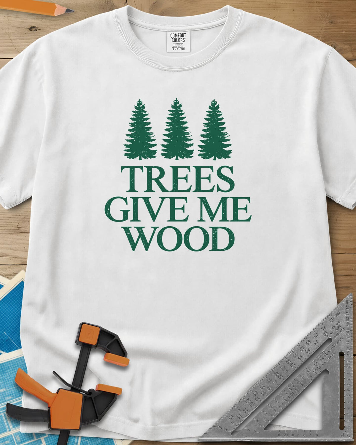 Trees Give Me Wood heavyweight tee in White, three evergreen trees above worn serif lettering