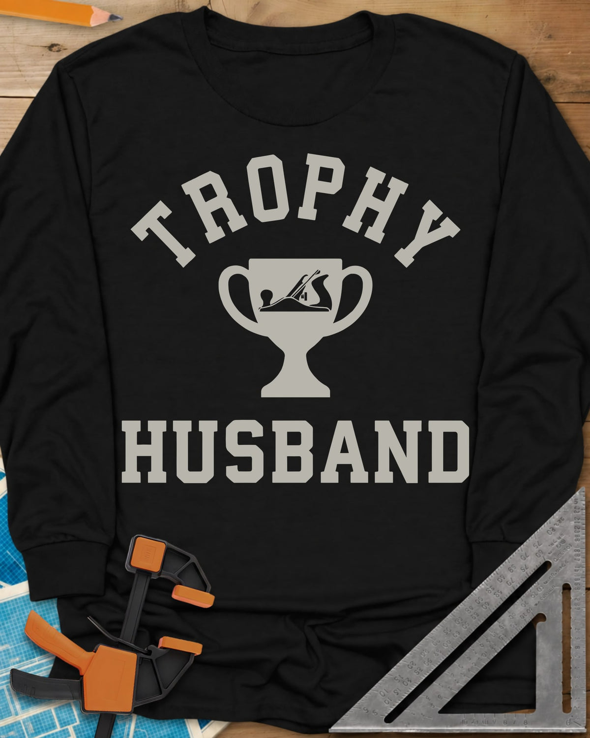 Trophy Husband Woodworker long sleeve shirt in Black, varsity lettering around a trophy cup with a hand plane on it