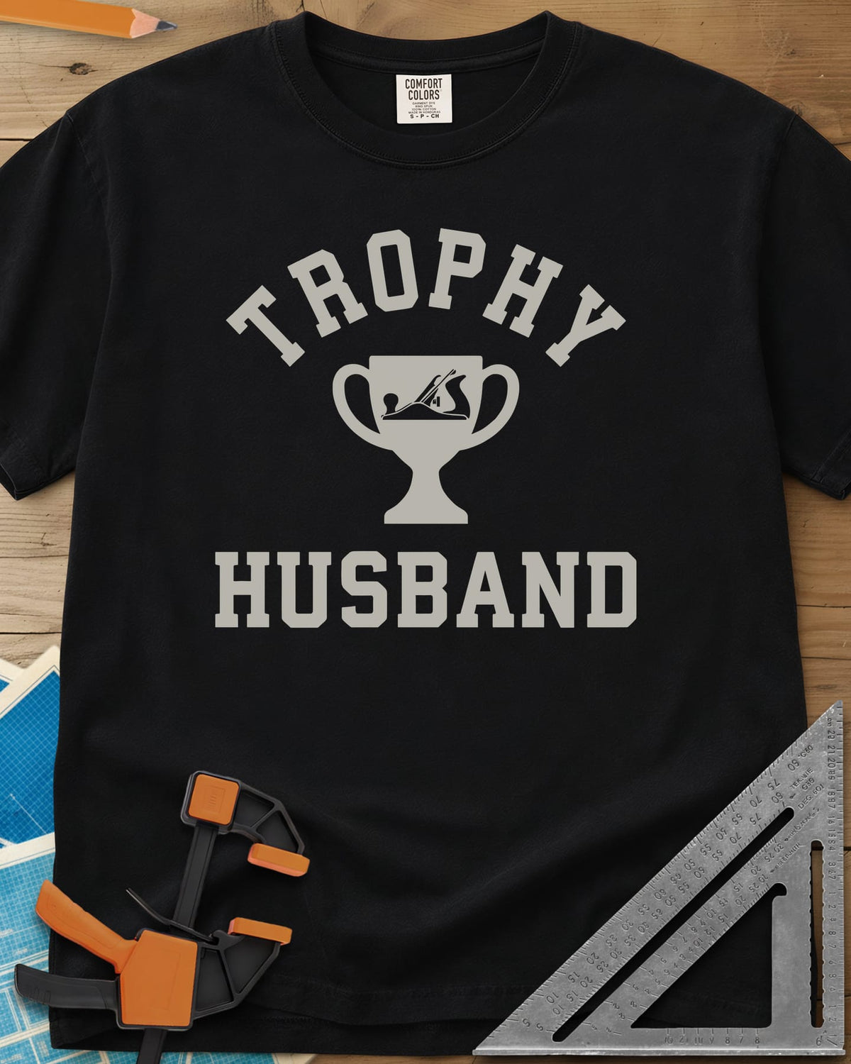Trophy Husband Woodworker heavyweight tee in Black, varsity lettering around a trophy cup with a hand plane on it