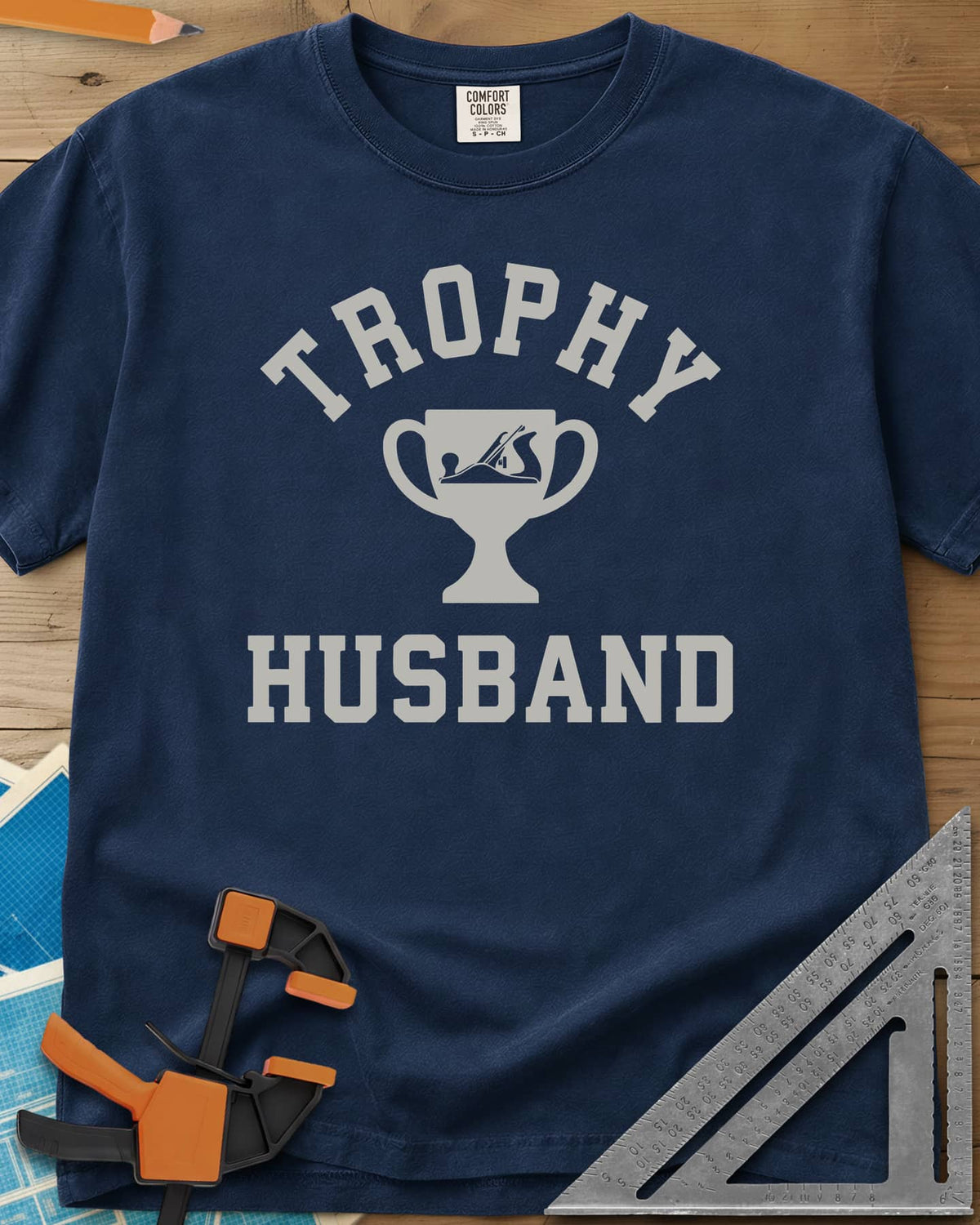 Trophy Husband Woodworker heavyweight tee in Navy, varsity lettering around a trophy cup with a hand plane on it