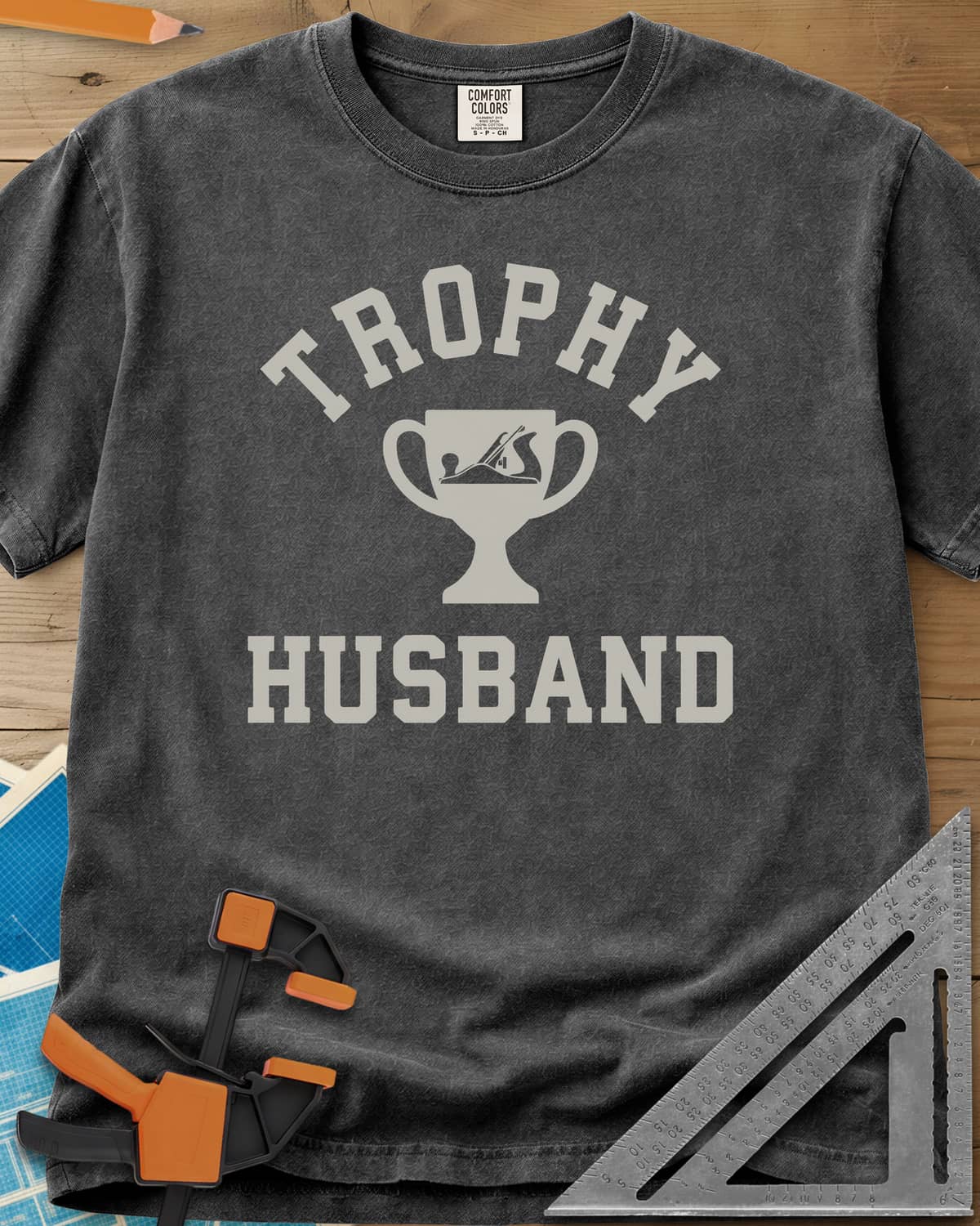 Trophy Husband Woodworker heavyweight tee in Pepper, varsity lettering around a trophy cup with a hand plane on it