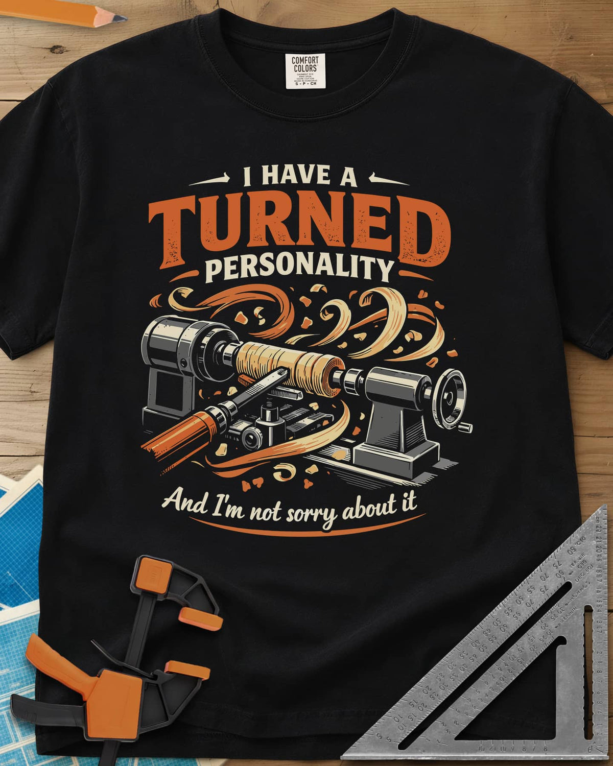 Turned Personality heavyweight tee in Black, a wood lathe spinning a blank in a spray of orange shavings