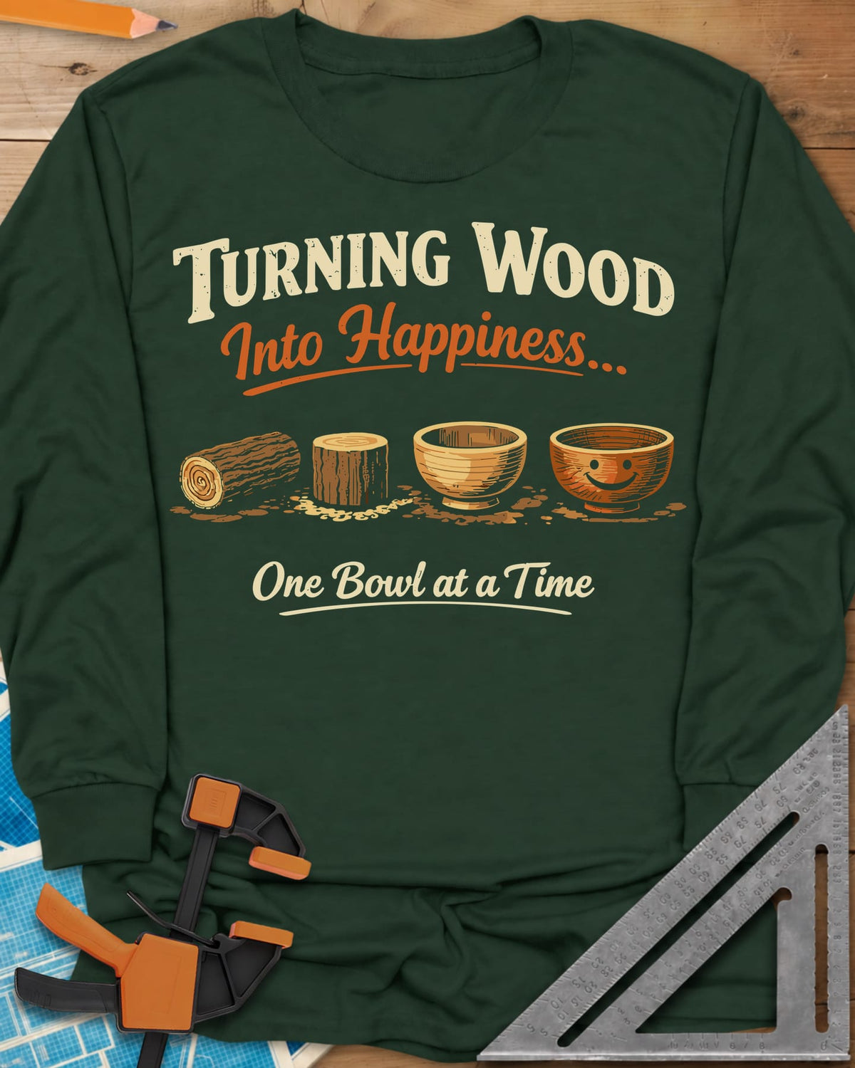 Turning Happiness long sleeve shirt in Forest Green, a log, a stump, a plain bowl and a bowl with a smiley face