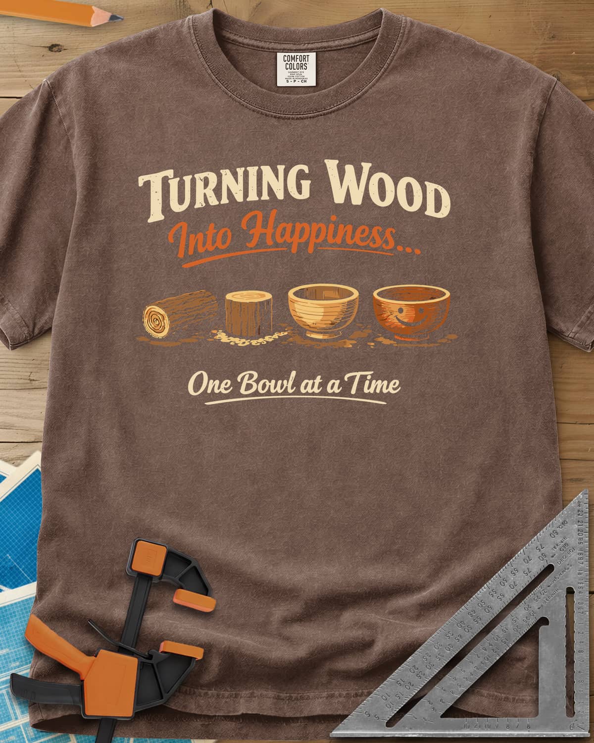 Turning Happiness heavyweight tee in Espresso, a log, a stump, a plain bowl and a bowl with a smiley face