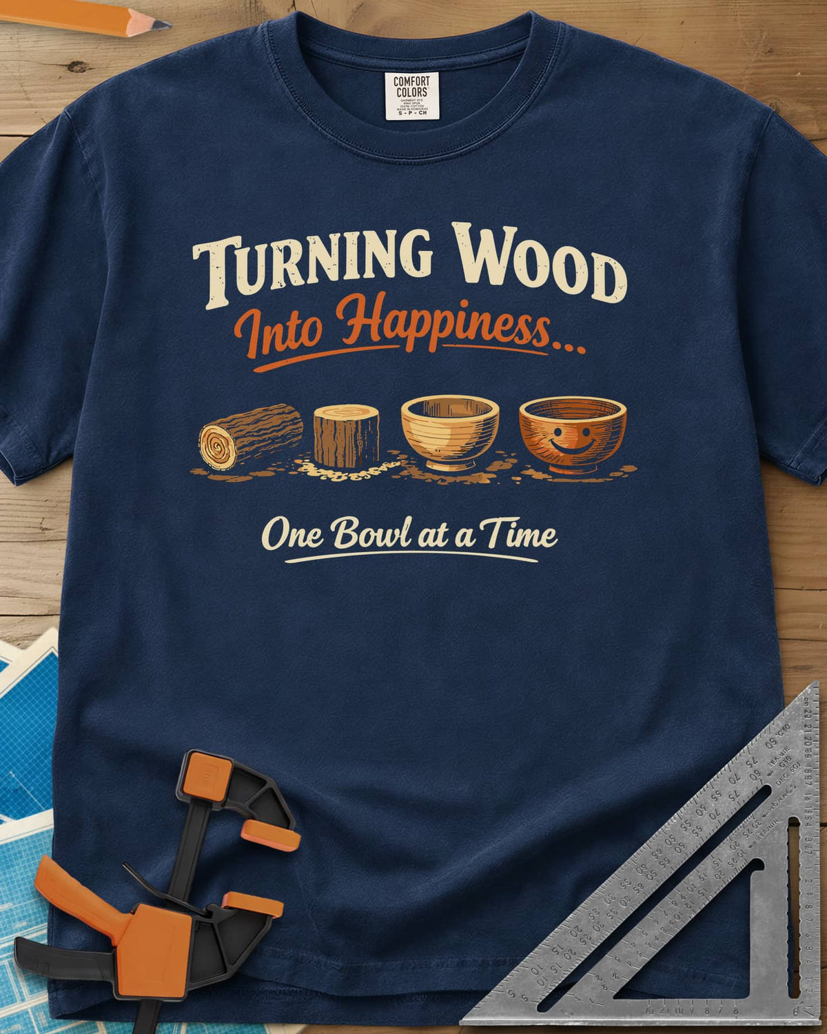 Turning Happiness heavyweight tee in Navy, a log, a stump, a plain bowl and a bowl with a smiley face