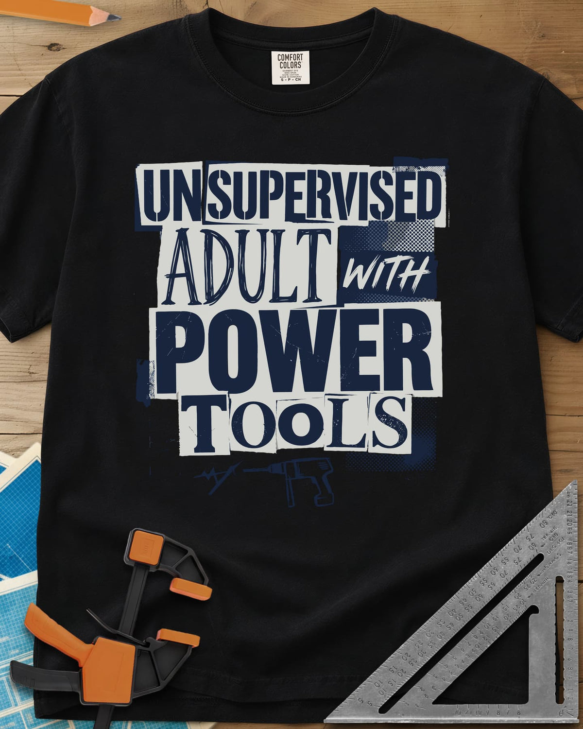 Unsupervised Adult Power Tools Humor heavyweight tee in Black, cut-paper ransom-note lettering with a small drill underneath