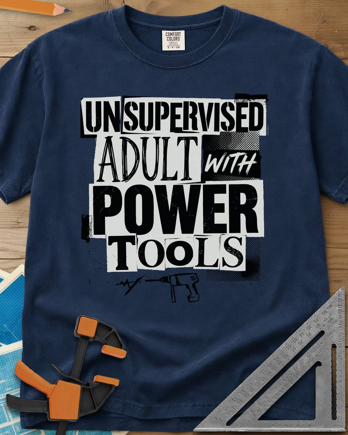 Unsupervised Adult Power Tools Humor heavyweight tee in Navy, cut-paper ransom-note lettering with a small drill underneath