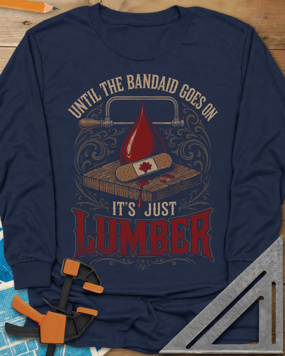 Until The Bandaid Goes On It's Just Lumber long sleeve shirt in Navy, frame saw, red drop and a bandaid on a board with
