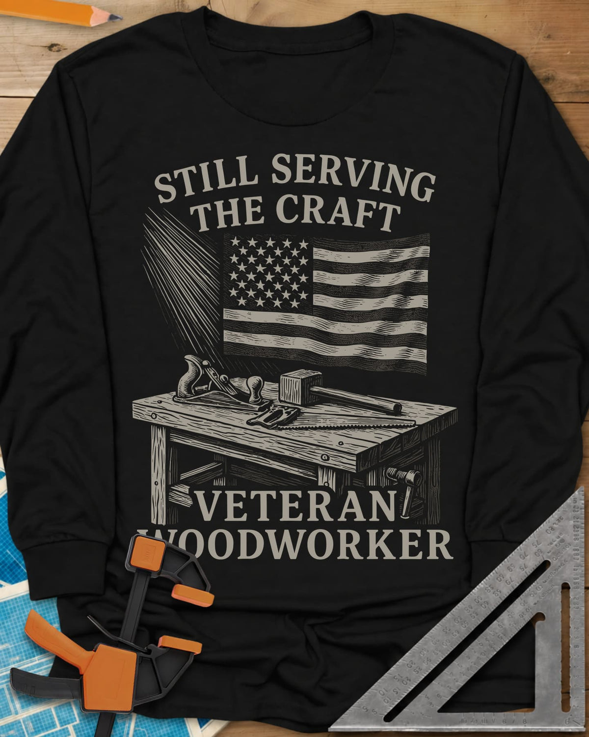 Veteran Woodworker long sleeve shirt in Black, an American flag over a workbench with a plane, mallet and saw