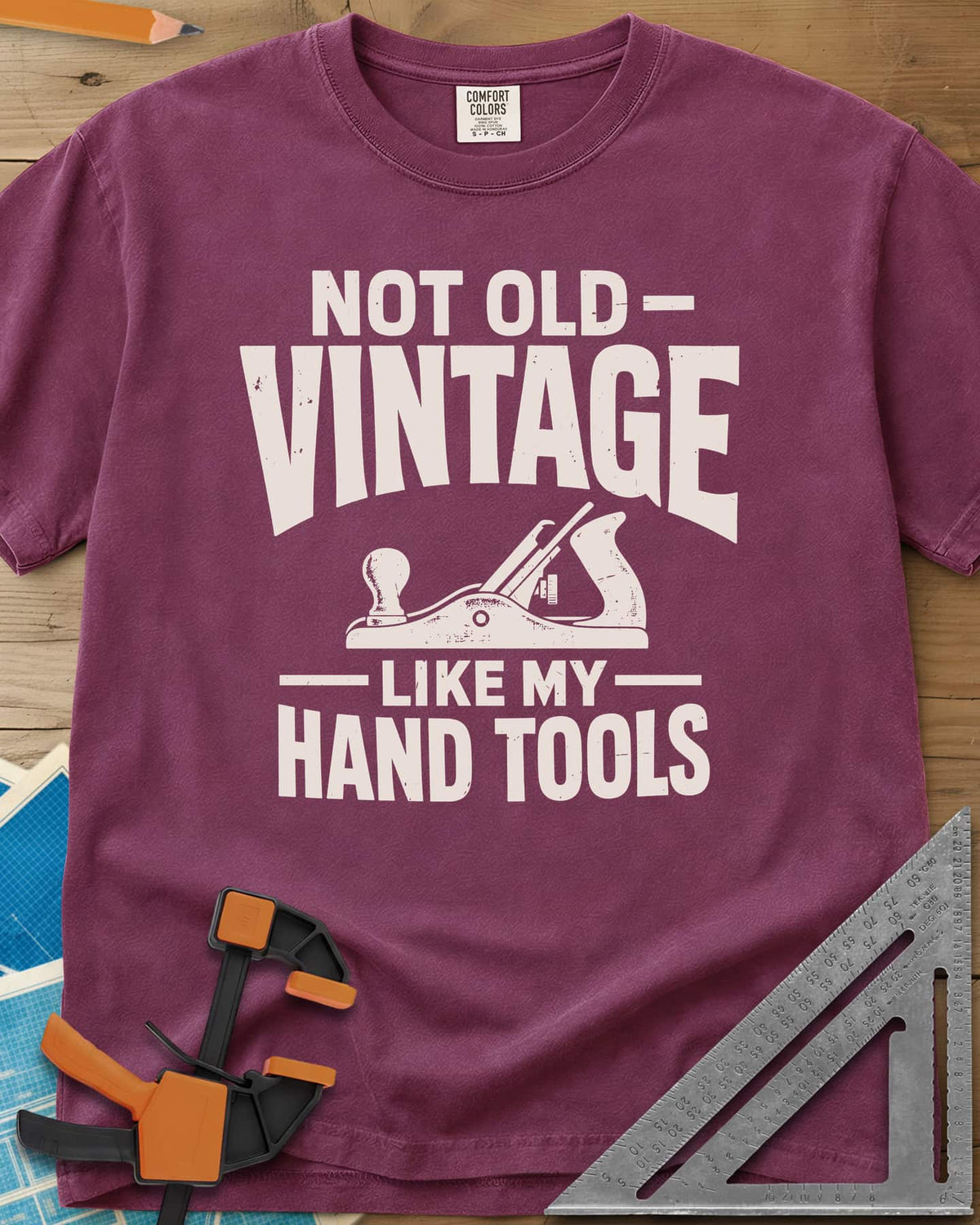 Vintage Tools heavyweight tee in Berry, a small bench plane between worn block lettering
