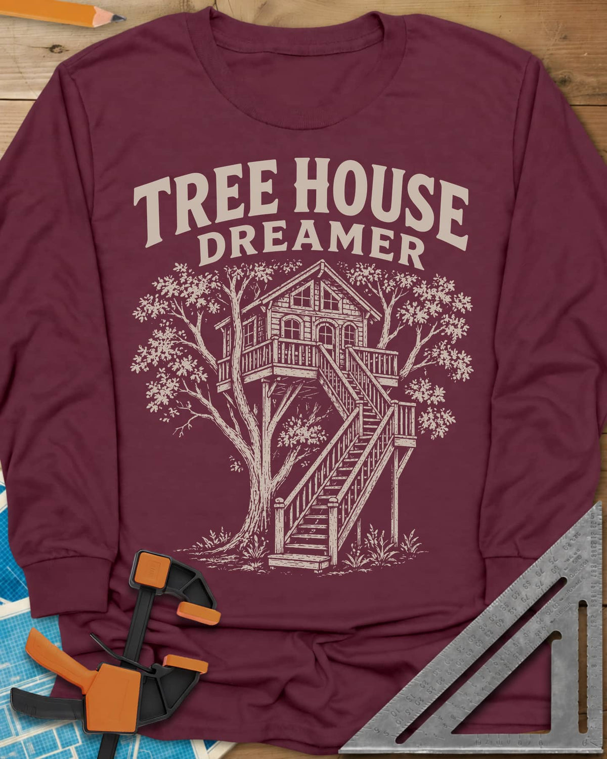 Vintage Tree House Dreamer long sleeve shirt in Maroon, engraved-style treehouse with a railed deck and wide stairs