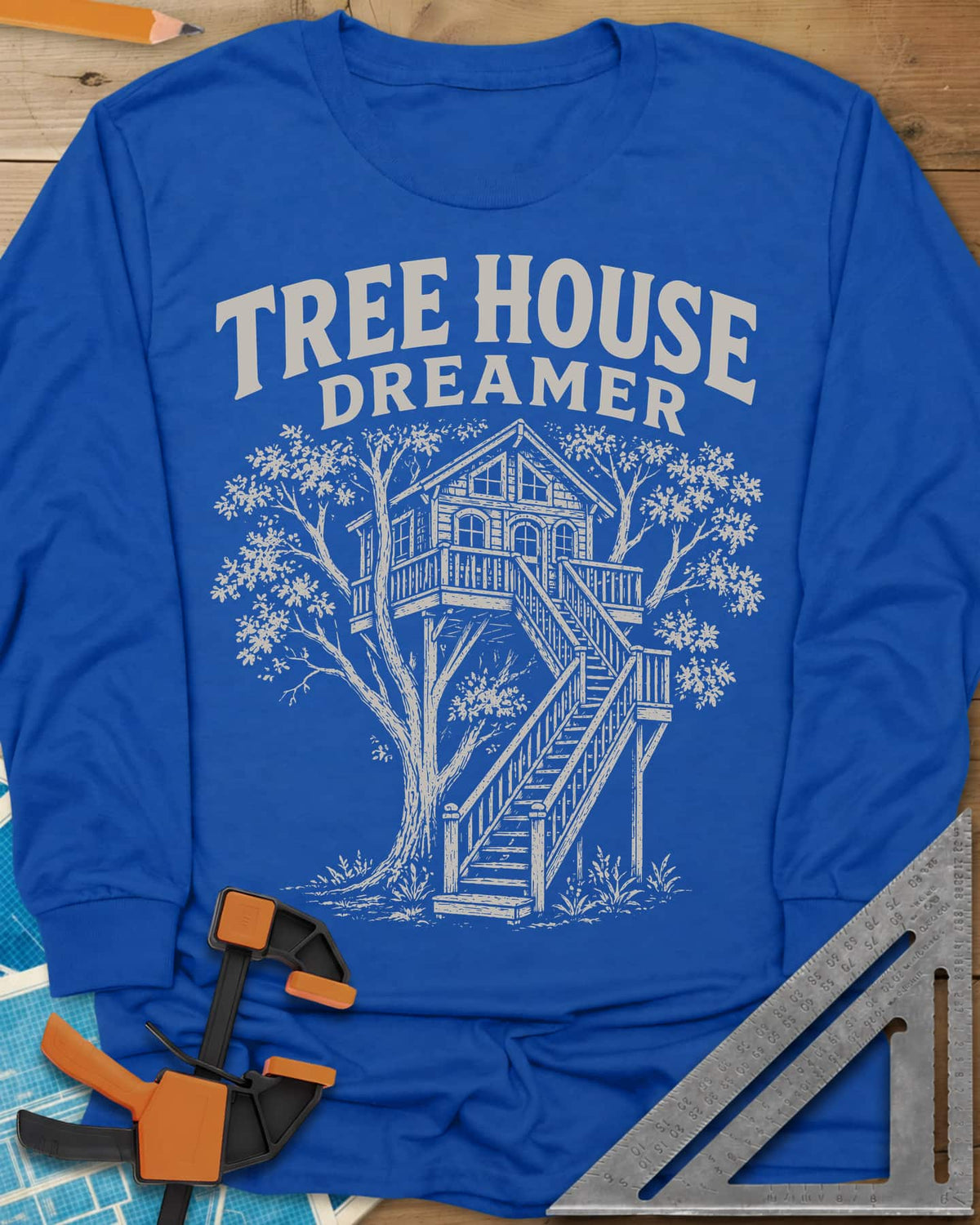 Vintage Tree House Dreamer long sleeve shirt in Royal, engraved-style treehouse with a railed deck and wide stairs