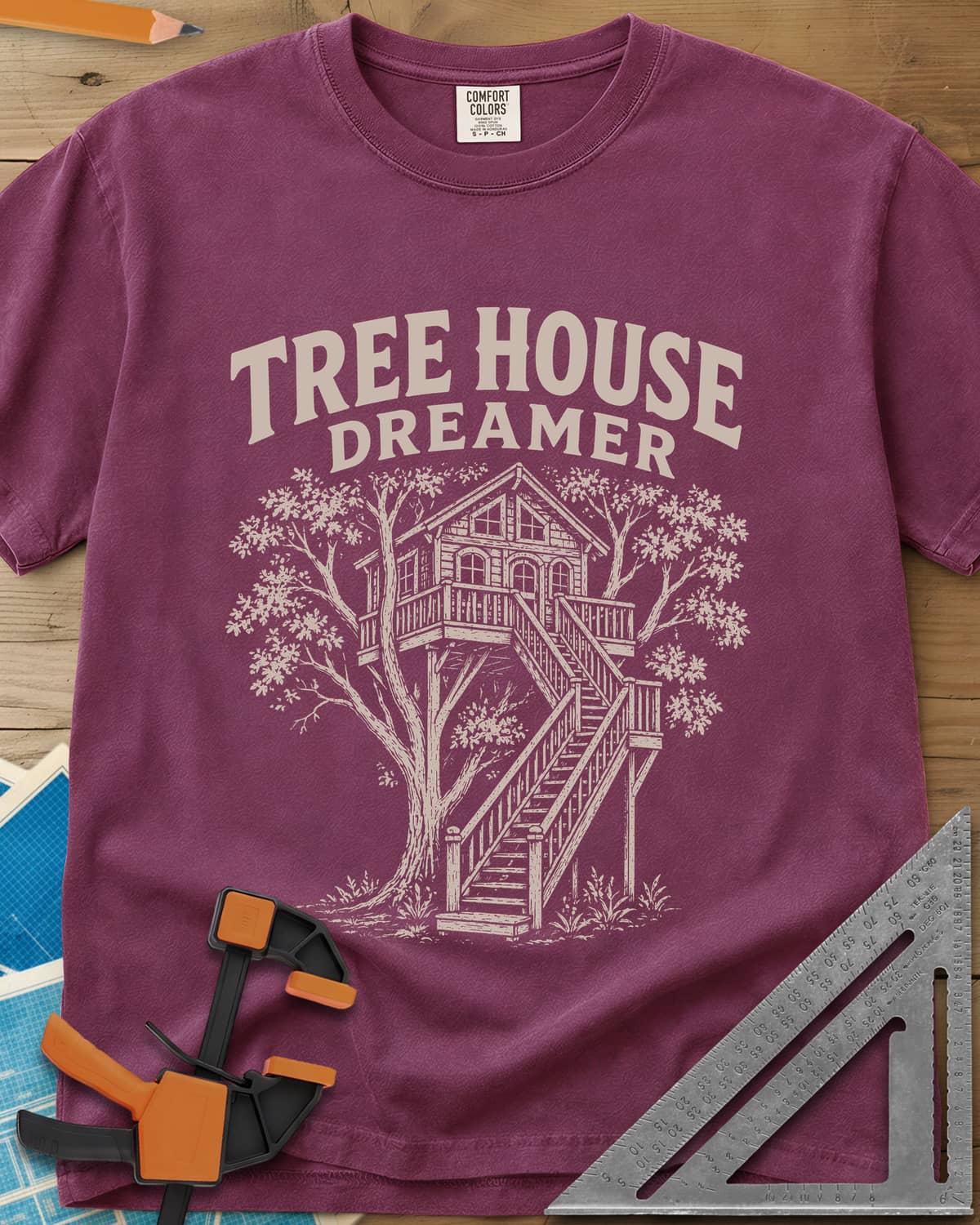 Vintage Tree House Dreamer heavyweight tee in Berry, engraved-style treehouse with a railed deck and wide stairs