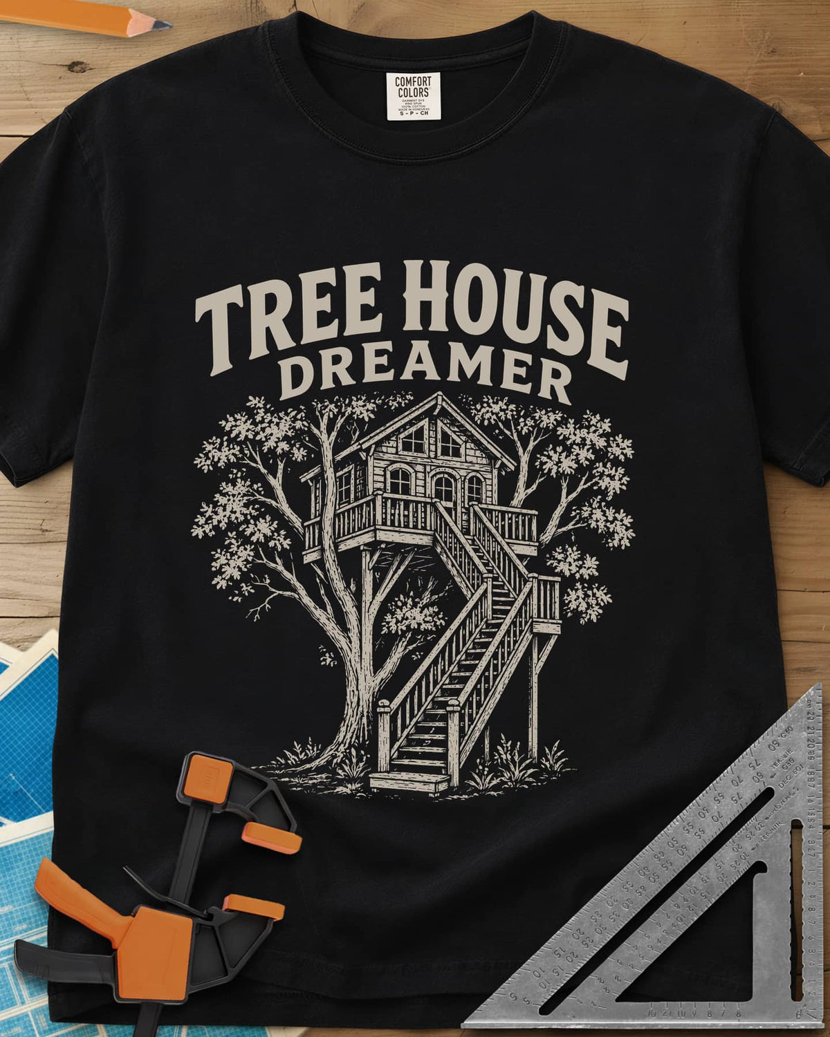 Vintage Tree House Dreamer heavyweight tee in Black, engraved-style treehouse with a railed deck and wide stairs