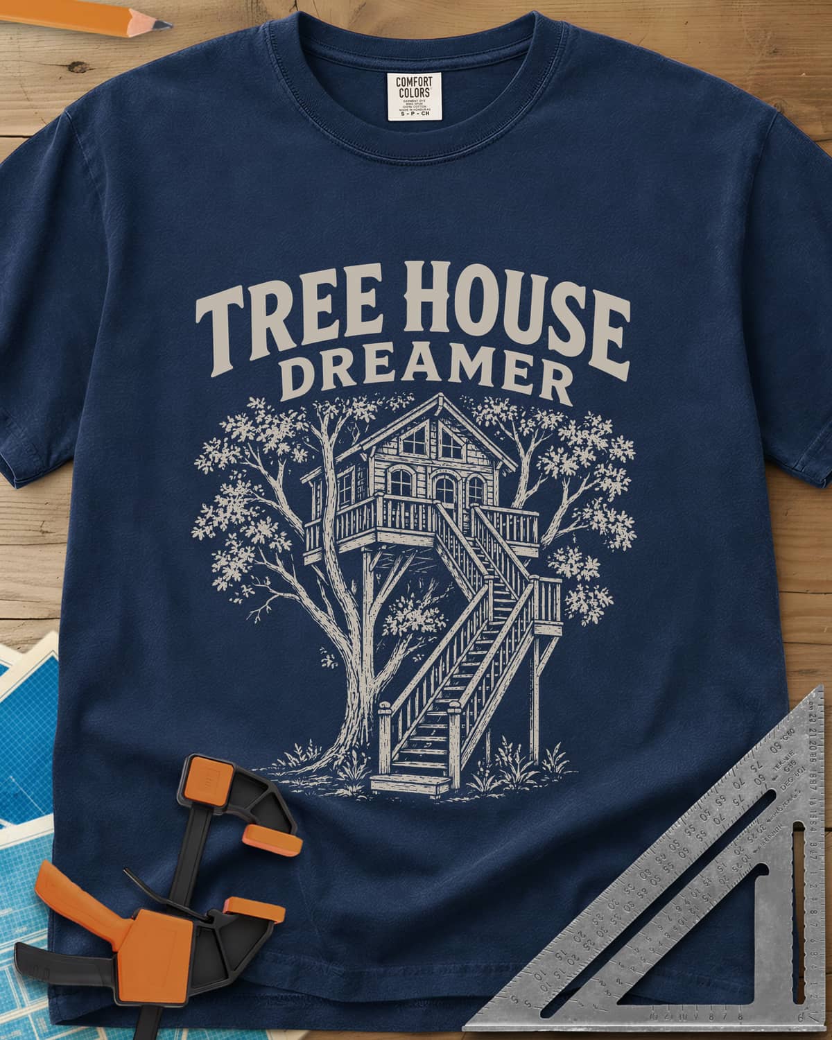 Vintage Tree House Dreamer heavyweight tee in Navy, engraved-style treehouse with a railed deck and wide stairs