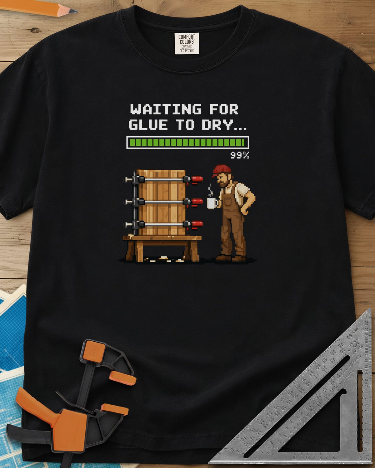 Waiting For Glue To Dry heavyweight tee in Black, pixel-art woodworker with a coffee mug beside a clamped glue-up