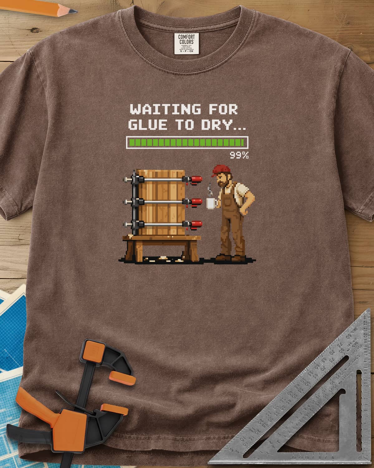 Waiting For Glue To Dry heavyweight tee in Espresso, pixel-art woodworker with a coffee mug beside a clamped glue-up